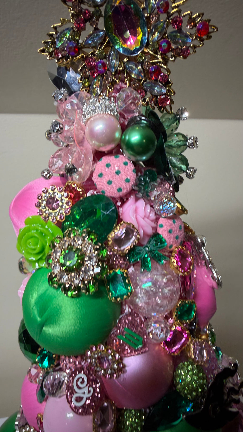 A luxurious decorative Christmas or Table Top tree made from pink and green ornaments, beads, and sequins!