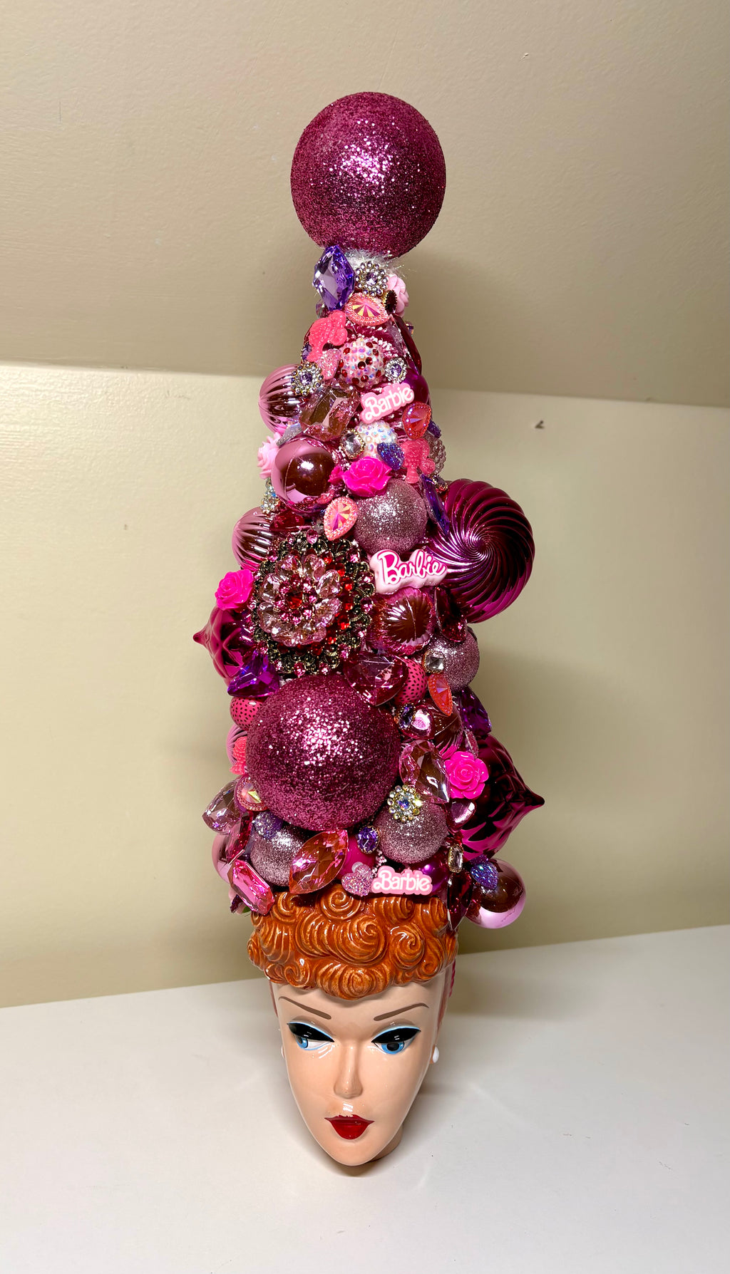 Beautiful decorative bejeweled doll themed Christmas or table top tree  made from pink and purple glittery ornaments, beads, sequins, and small embellishments, displayed in a vintage  Barbie 3D Mug