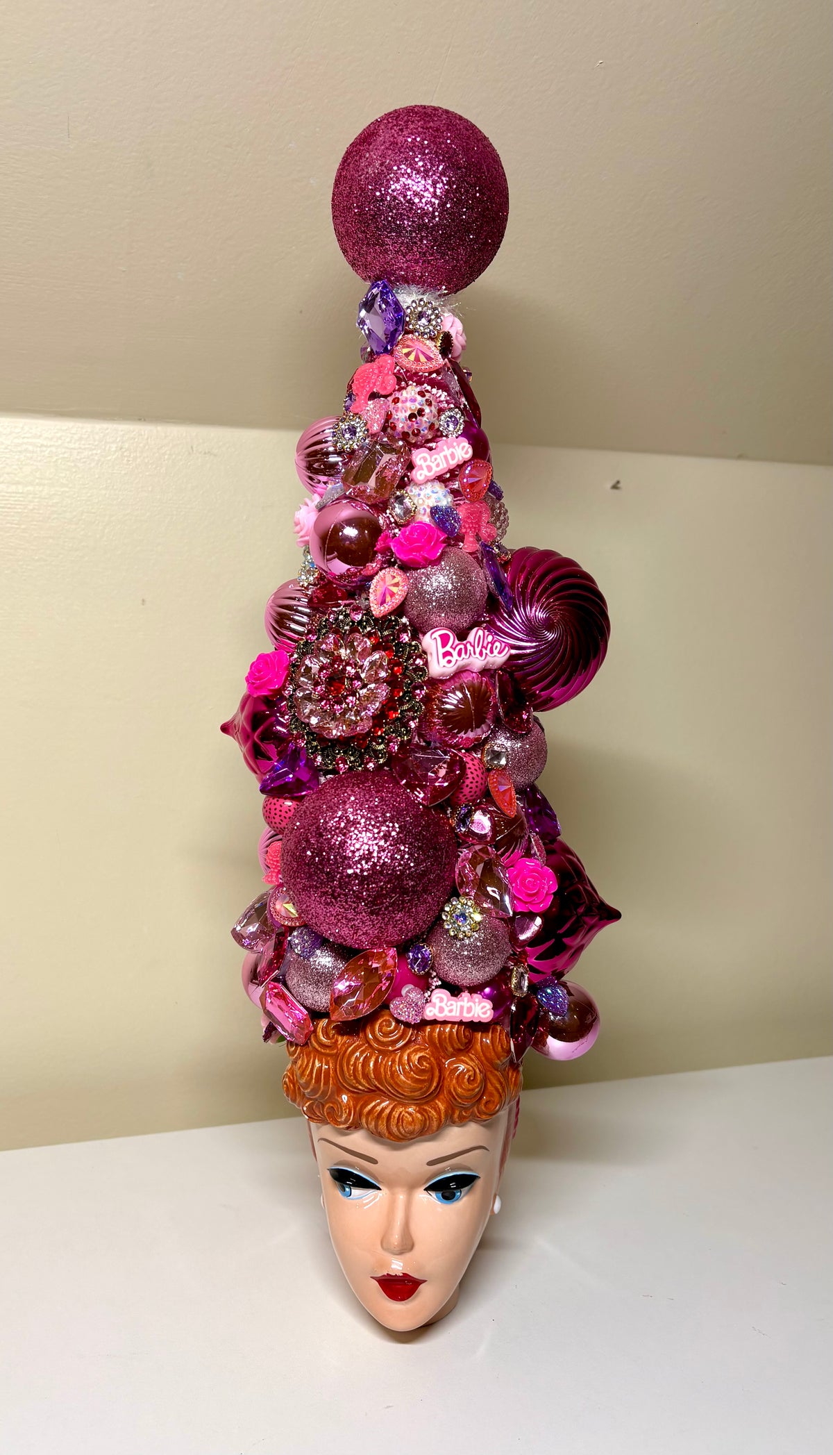 Beautiful decorative bejeweled doll themed Christmas or table top tree  made from pink and purple glittery ornaments, beads, sequins, and small embellishments, displayed in a vintage  Barbie 3D Mug