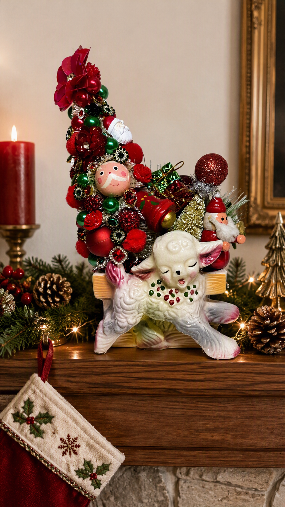 A festive Christmas holiday tree ornament decoration featuring a white sheep figurine with a green and red patterned collar, a small Santa Claus figure, and a tall decorated Christmas tree with red ornaments, green baubles, and a nutcracker, displayed on a wooden mantel with a lit red candle, pinecones, and a stocking.