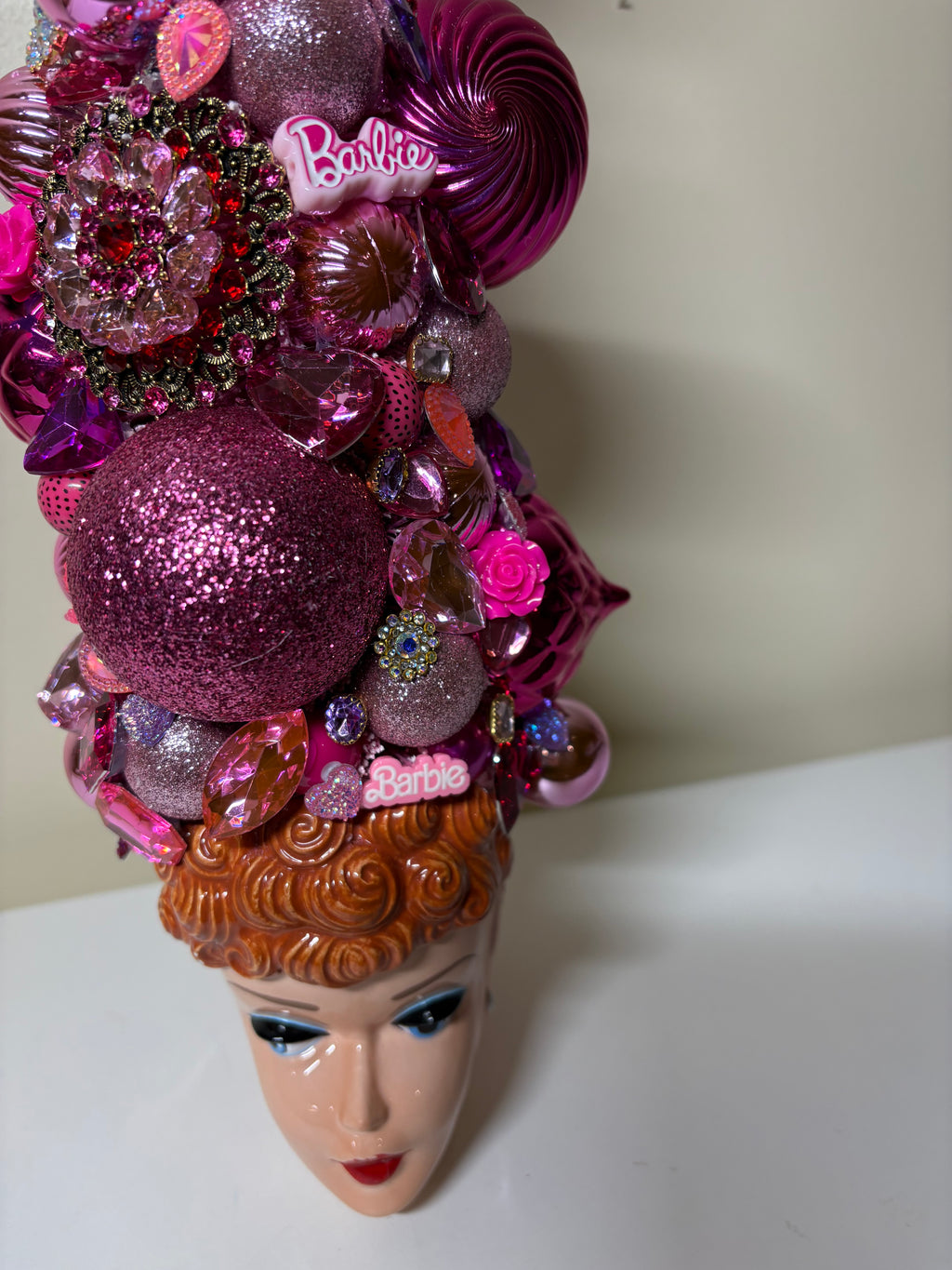  A handcrafted decorative bejeweled doll themed Christmas or table top tree  made from pink and purple glittery ornaments, beads, sequins, and small embellishments, displayed in a vintage  Barbie 3D Mug